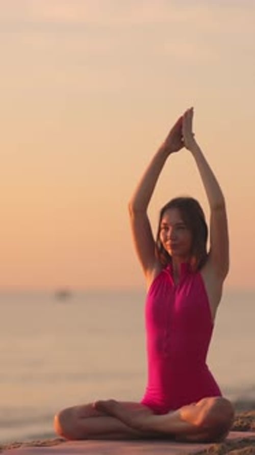 Woman Practicing Yoga at Sunset By the Beach in Slow Motion