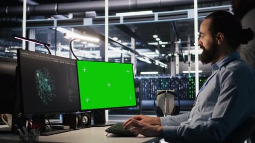 Data Center Technician Doing Software Updates Using Green Screen Mockup Computer