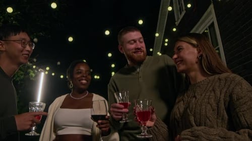 Friends Toasting Wine Glasses at Outdoor Night Party