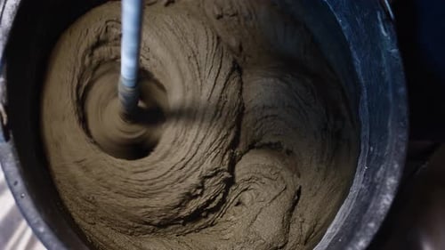 Industrial Mixer Tool Mixing Adhesive in Bucket