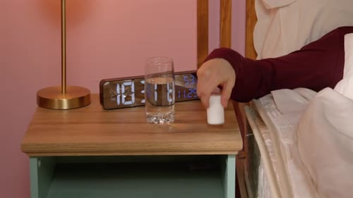 Person Takes Pills with Water Before Bedtime