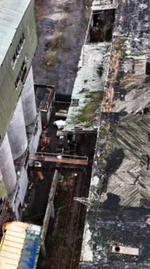 Holes in the roof of a warehouse in old abandoned chemical plant.