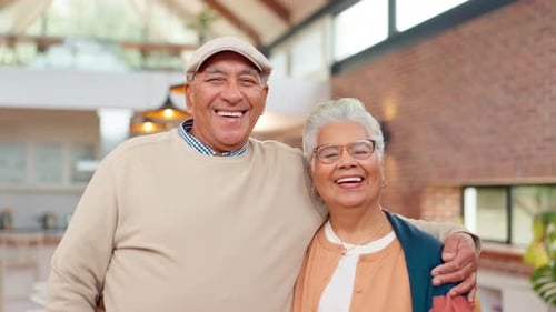Smiling Senior Couple Embrace Affectionately in Home