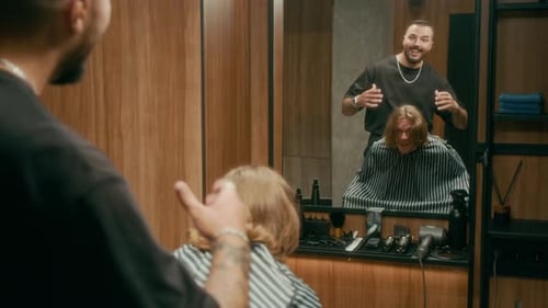 Surprised Young Barbershop Client Admiring New Hairdo in Mirror