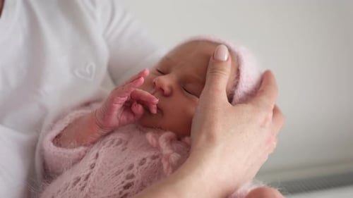 Sleeping Infant in Parent's Arms Indoors