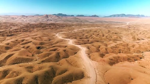 NAMIBIA: Endless Desert Road Cutting Through a Vast Arid Landscape