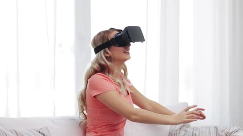 Smiling woman in VR headset sitting on couch