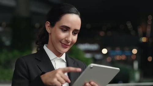 Charming Woman Standing Scrolling Digital Tablet Surfing on Internet in Office Building