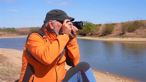 Senior Man Photographing the Rural Landscape on Sunny Day