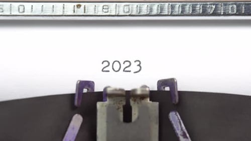 2023 year word closeup being typing and centered on a sheet of paper on old vintage typewriter