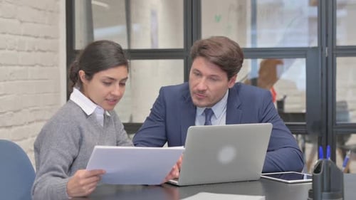 Colleagues Collaborating in Office Workplace Environment