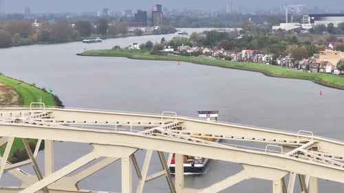 Cargo vessel full of goods partially obstructed by bridge structure