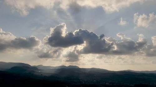 Dramatic sunbeams breaking through dark clouds