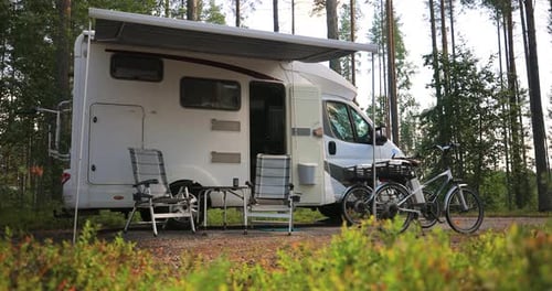 Camper Van Parked in Forest for Summer Camping