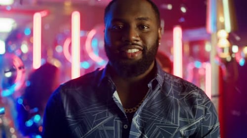 Man Enjoying Nightlife Celebration with Colorful Lights
