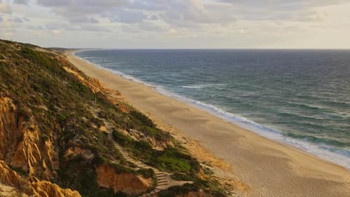 A Beach with a Rocky Cliff Overlooking the Ocean