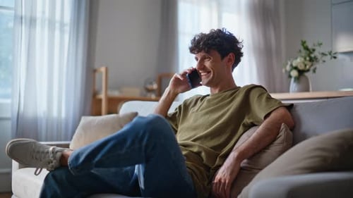 Young Adult Relaxing at Home Talking on Phone