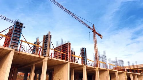 View on the top of the building under construction. Metal rebars and panels set on the roof.