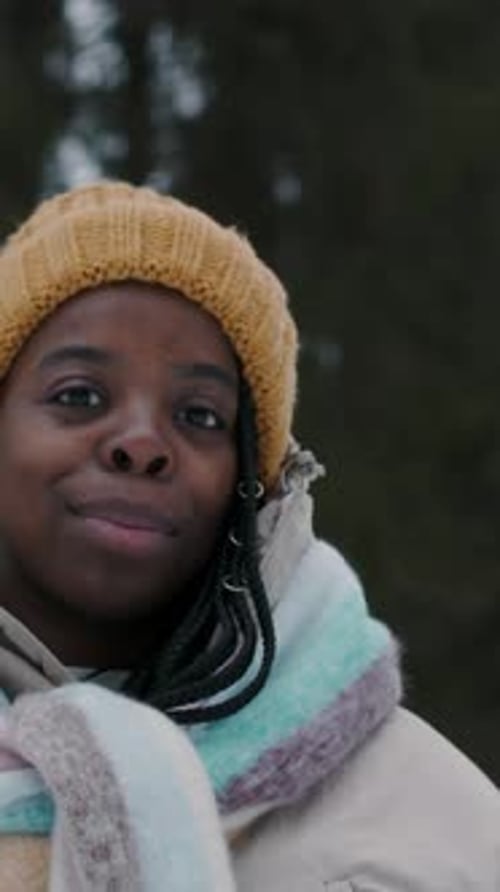 Portrait of Positive African American Woman in Winter Clothes Outdoors