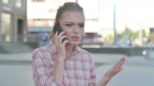 Woman Having Emotional Phone Call in Urban Setting