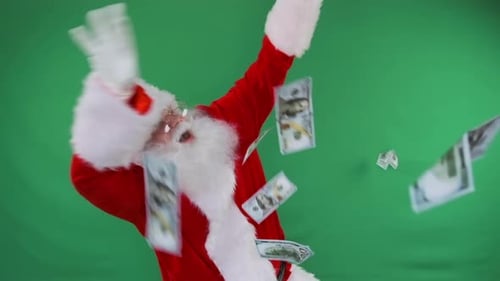 Santa Tosses Money on a Green Screen Perfect for Promos