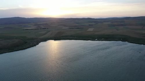 Aerial View Of Lake Farmland And Sunset