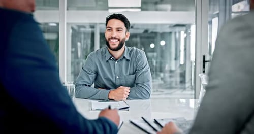 Job interview, smile and man in boardroom with document, discussion or meeting in onboarding