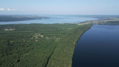 Aerial View of a Lush Green Landscape Surrounded By Serene Waters and Beautiful Scenery Clip