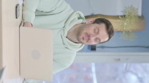 Vertical Video of Young Man Shaking Head in Acceptance at Work