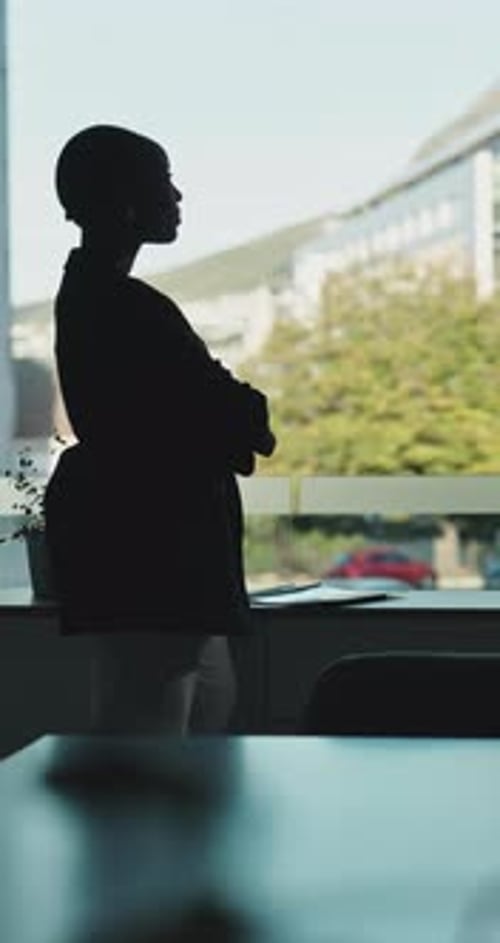 Business, woman and arms crossed at window in office for architecture, career ambition