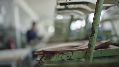 shoe manufacturing process on a conveyor system within a workshop environment