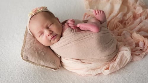 Baby Peacefully Sleeping Wrapped in Neutral Blanket