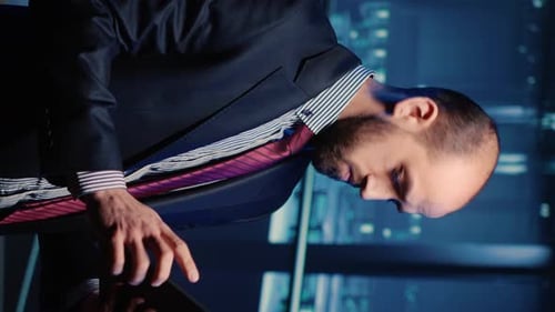 Young Adult Using Tablet in a Dark Office