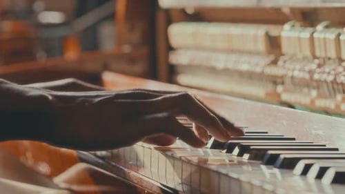 Close-Up of Hands of Black Musician Playing Vintage Piano Keys