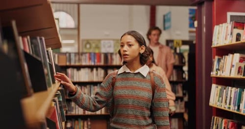 Girl, book and student in library to search at university, college or school campus for education
