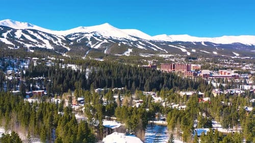 Aerial Drone View of Hotels and Appartments on Ski Resort in Winter Mountain Town Covered in Snow wi