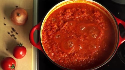 Top View of Boiling Tomato Italian Sauce for Pasta or Pizza Cook on Stove in Saucepan