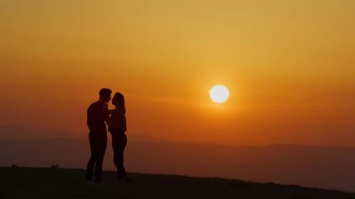 Romantic Couple Silhouette at Colorful Sunset