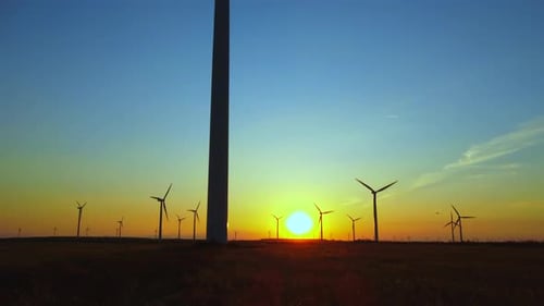 Windmill Turbines for electric power on the sunset. Alternative Energy