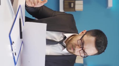 Vertical Video of Businessman working at a very busy pace in the office.