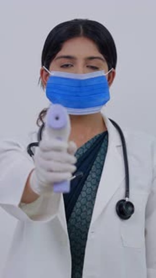 Young Woman Doctor Holding Non Contact Thermometer