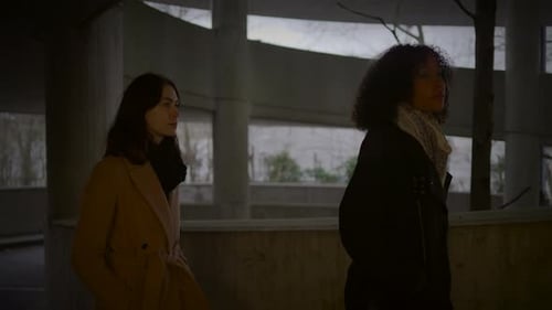 Lifestyle Portrait of Two Young Women Watching Tower Building Together