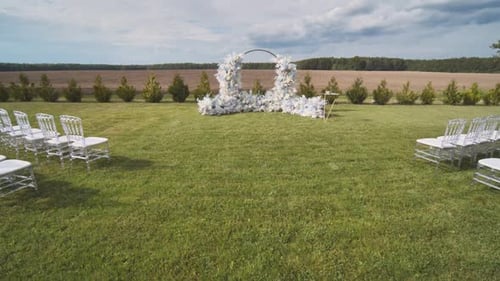 Elegant Wedding Venue with Floral Archway on Lawn