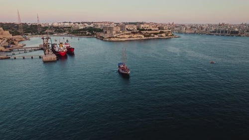 Aerial view of people jumping off the boat in La Valletta, Malta.