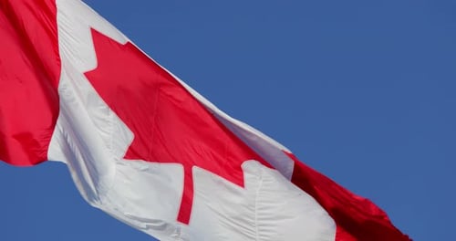 Canadian Flag Waving Proudly Against a Clear Sky