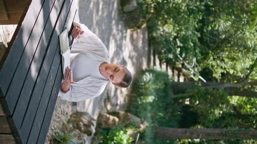 Woman Writes in Notebook Outdoors on Sunny Day