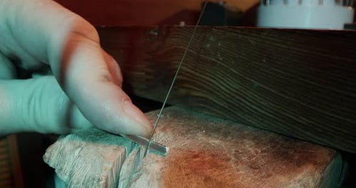 Crop Male Jeweler Using Piercing Saw