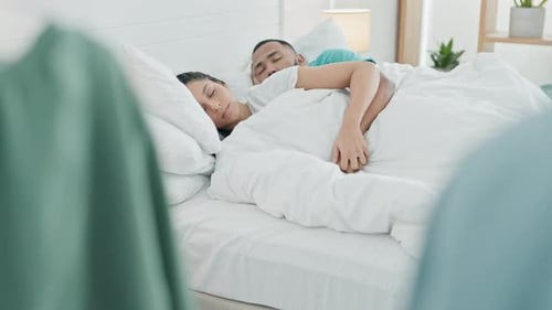 Young Adult Couple Sleeping and Holding Hands