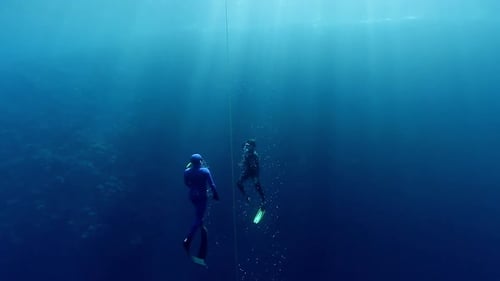 Freedivers ascend along the rope in the famous Blue Hole in the Red Sea in Egypt