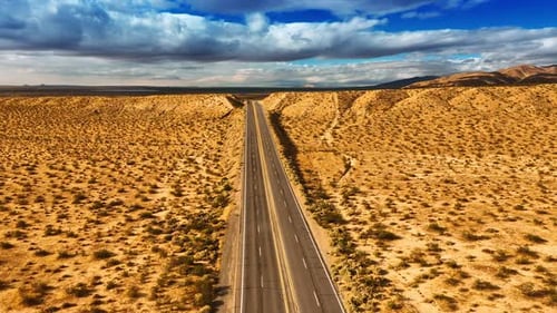 Footage above the highways in Nevada desert, USA. Gorgeous cloudscape in the sky at backdrop
